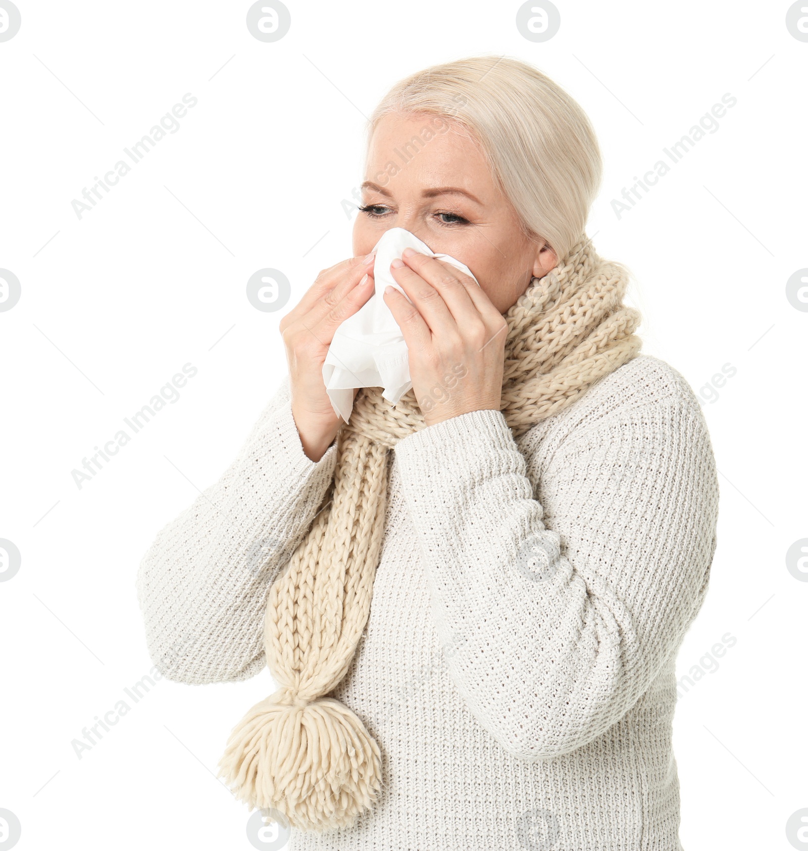 Photo of Mature woman with tissue suffering from cold on white background