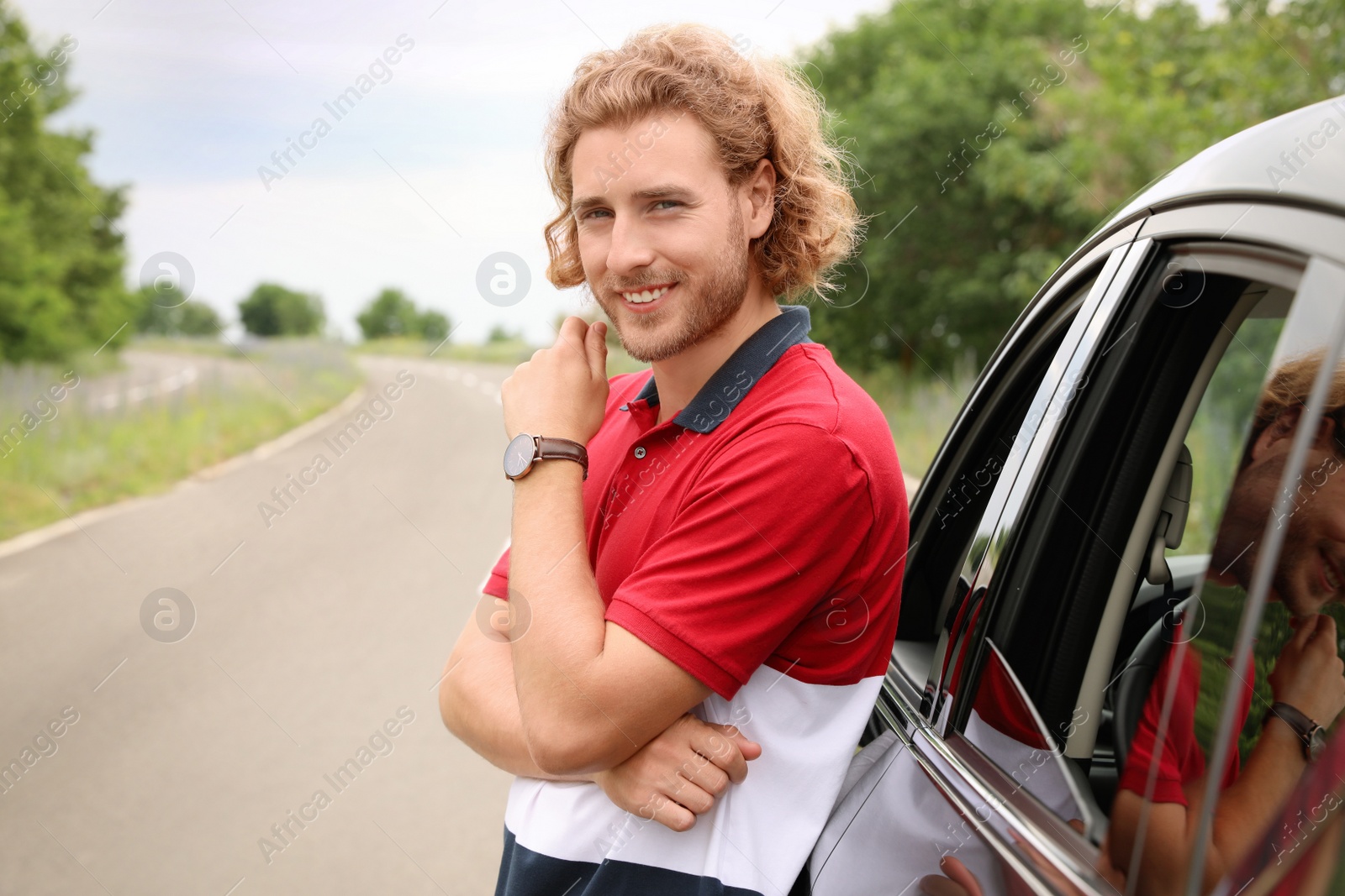 Photo of Attractive young man near luxury car outdoors