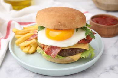 Delicious burger with fried egg and french fries served on white marble table, closeup