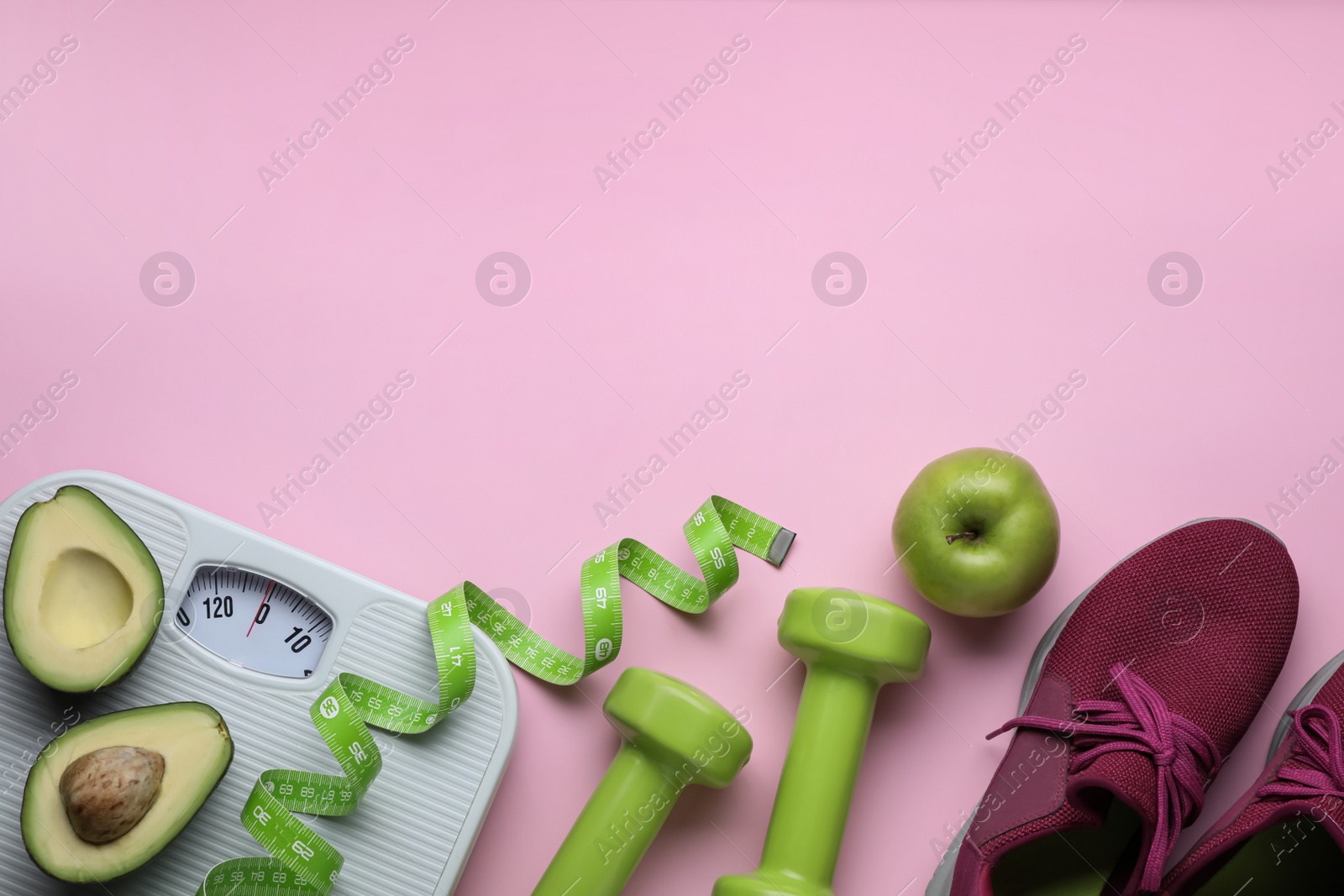 Photo of Flat lay composition with scales and measuring tape on pink background, space for text