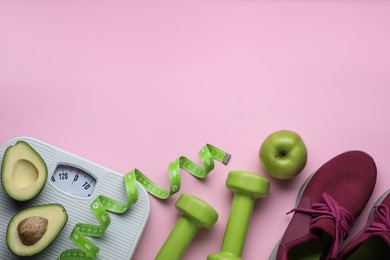 Flat lay composition with scales and measuring tape on pink background, space for text