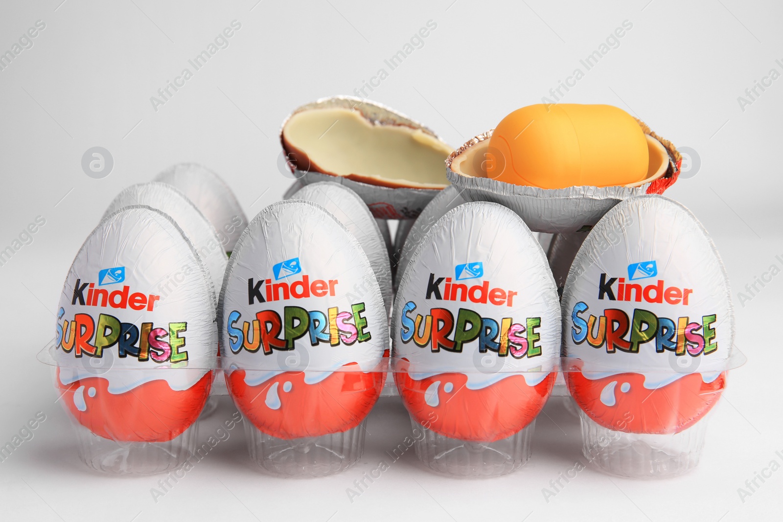 Photo of Sveti Vlas, Bulgaria - June 26, 2023: Kinder Surprise Eggs and capsule with toy in plastic tray on white background