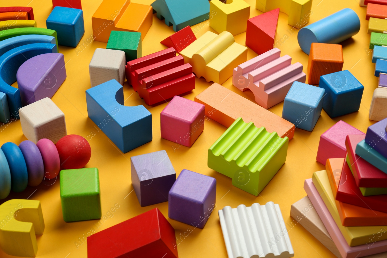 Photo of Different colorful children's toys on yellow background