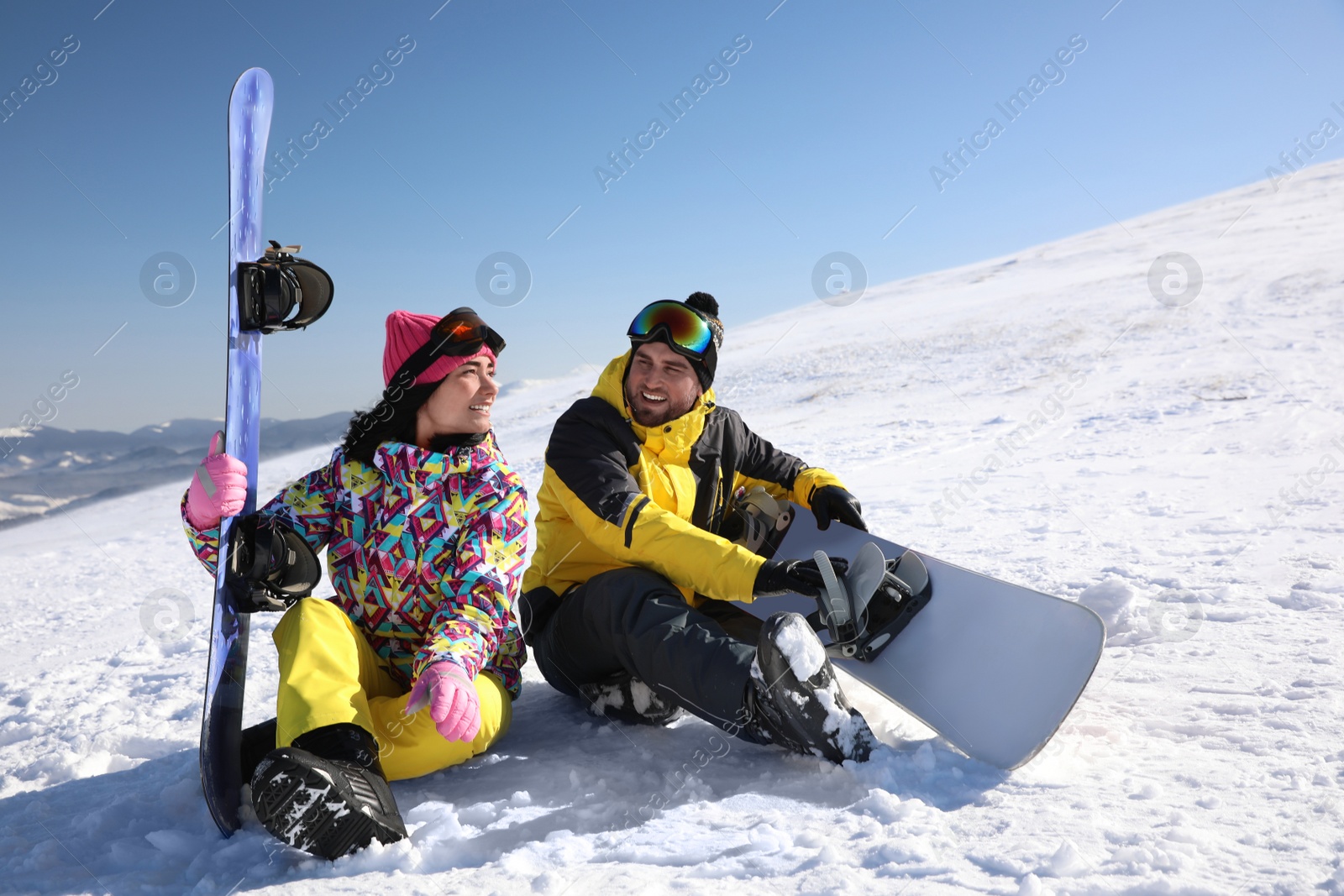 Photo of Couple with snowboards on hill. Winter vacation