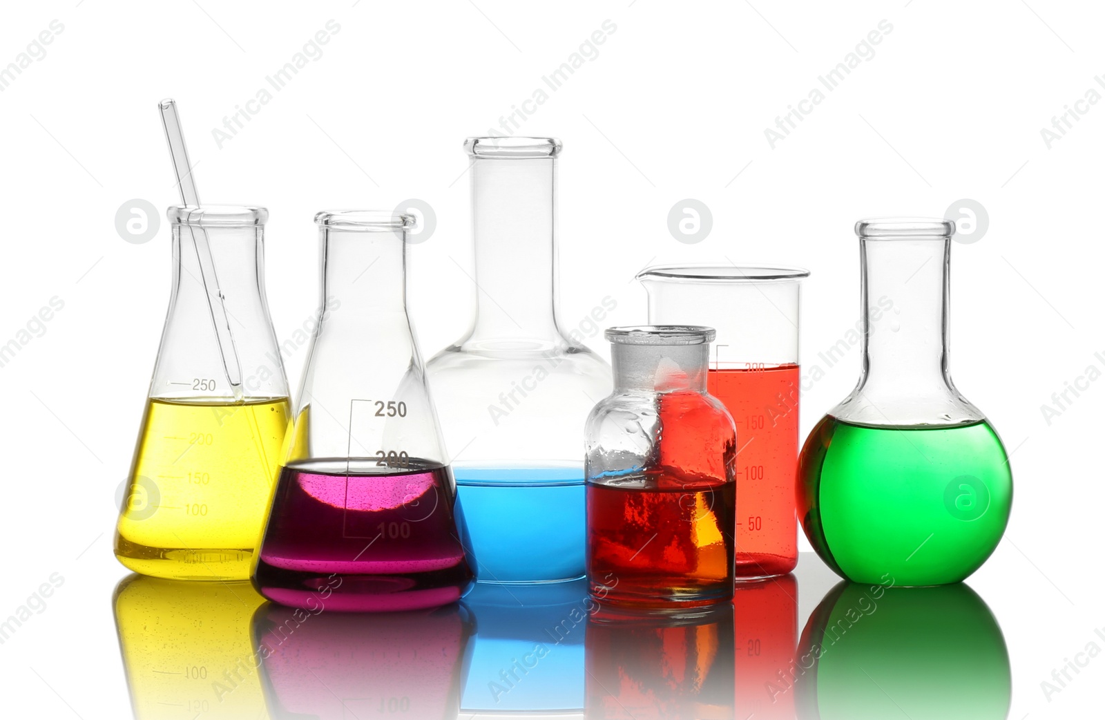 Photo of Different laboratory glassware with colorful liquids isolated on white
