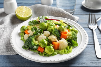 Photo of Plate of salad with Brussels sprouts served on table