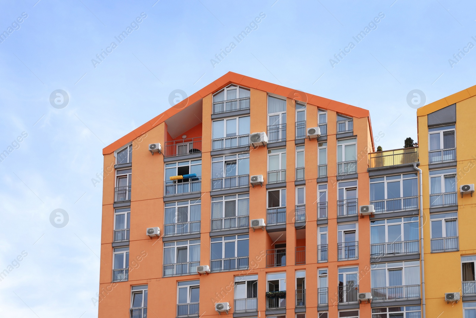 Photo of Colorful modern buildings with windows against sky. Urban architecture