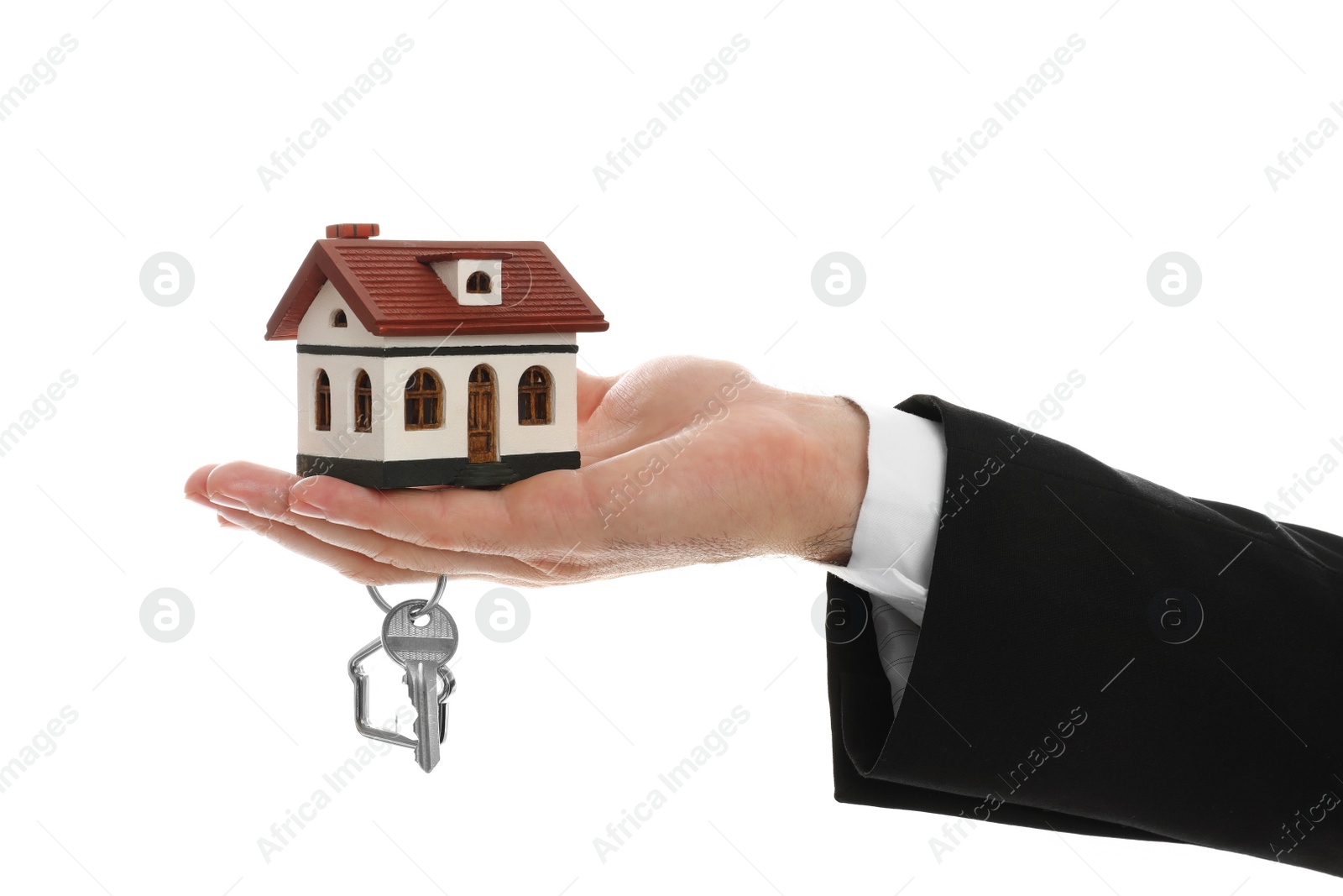 Photo of Real estate agent holding house model and key on white background, closeup