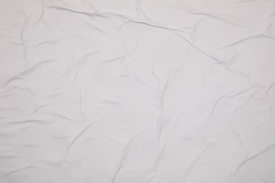 Photo of Top view of white creased blank poster as background, closeup