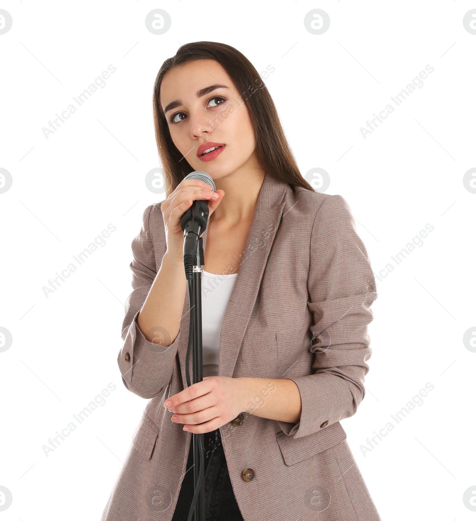 Photo of Young stylish woman in jacket posing with microphone on white background