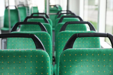 Photo of Rows of comfortable green seats in public transport