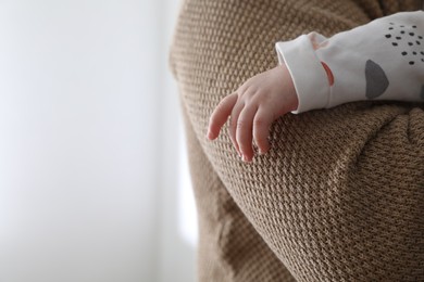 Father holding his daughter indoors, closeup. Space for text