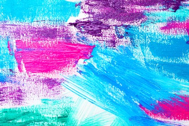 Photo of Strokes of colorful acrylic paints on white canvas, closeup