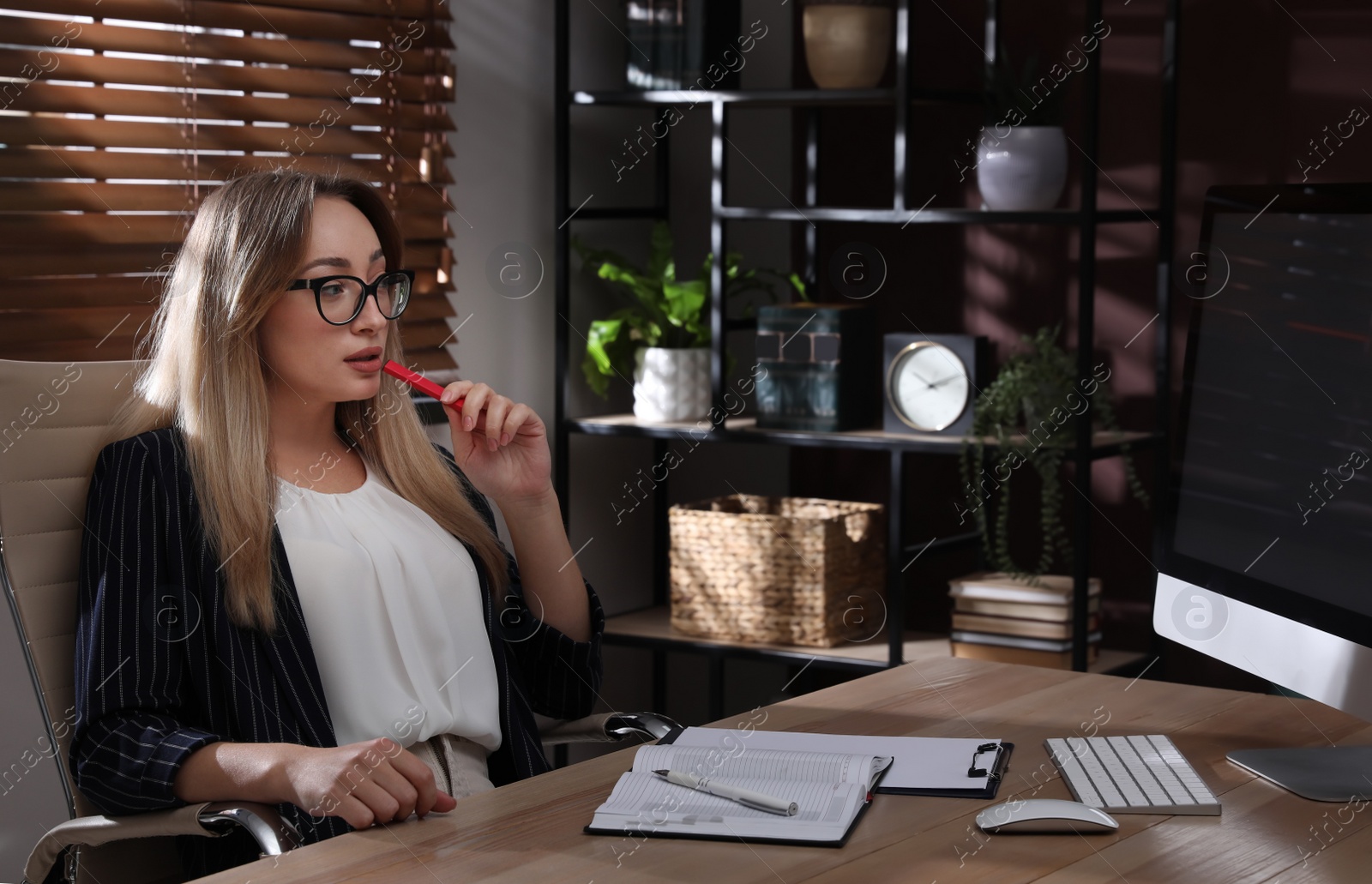 Photo of Beautiful young woman using disposable electronic cigarette at table in office