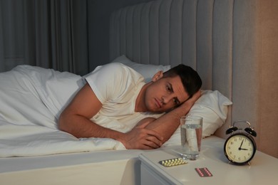 Photo of Man suffering from insomnia in bed at home