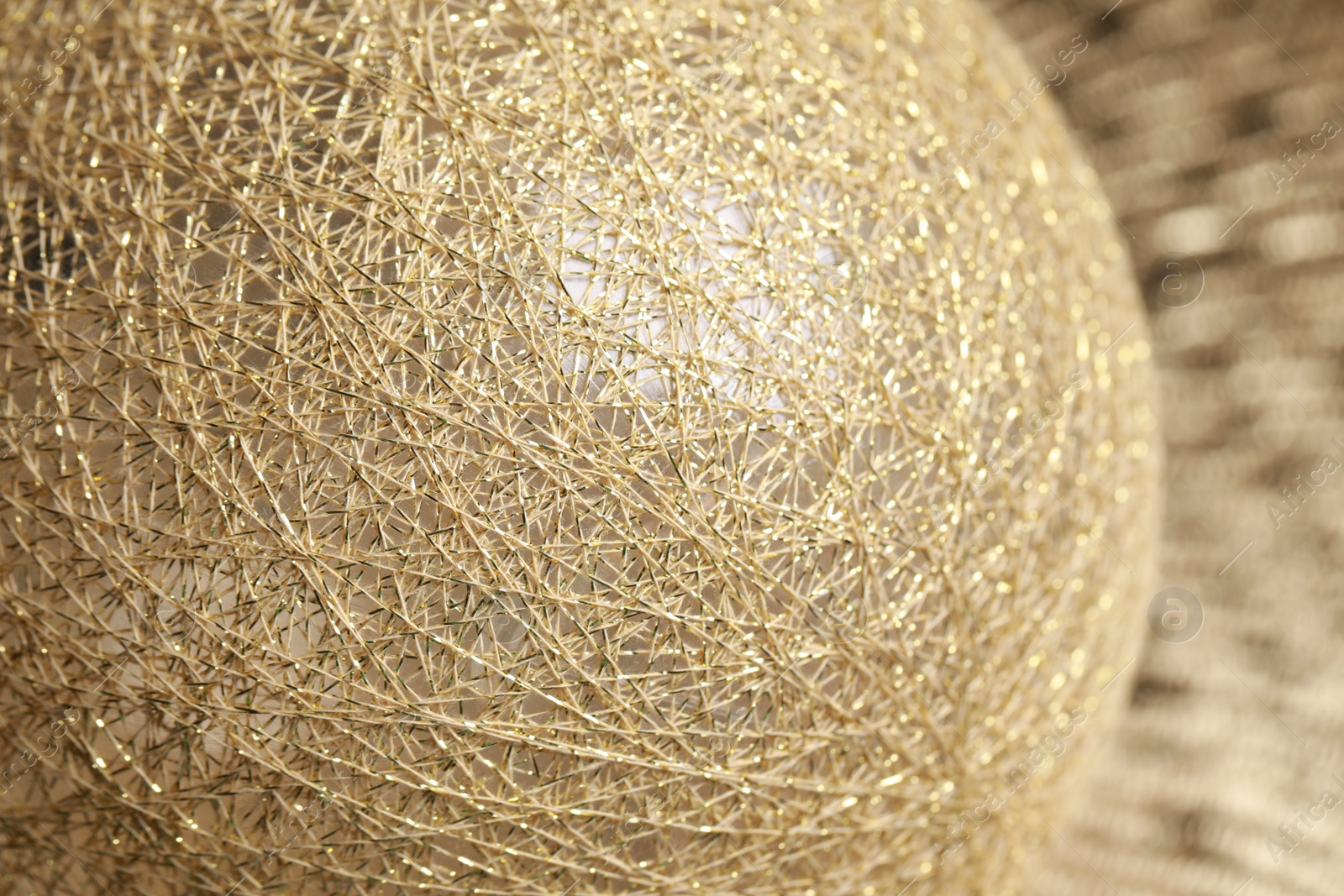 Photo of Texture of sphere made with golden threads, closeup