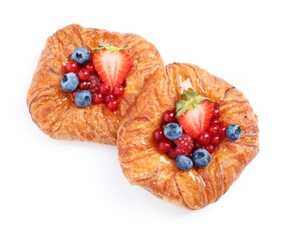 Fresh delicious puff pastry with sweet berries on white background, top view