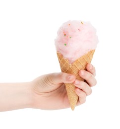 Woman holding waffle cone with cotton candy on white background, closeup