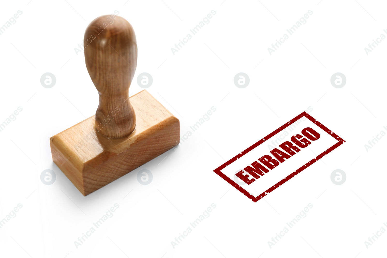 Image of Economic sanctions. Wooden stamp and red mark Embargo on white background