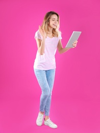 Woman using tablet for video chat on color background