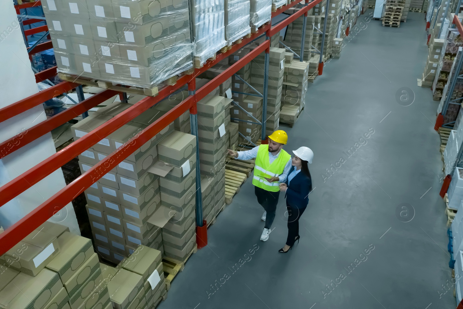 Image of Manager and worker at warehouse, above view. Logistics center