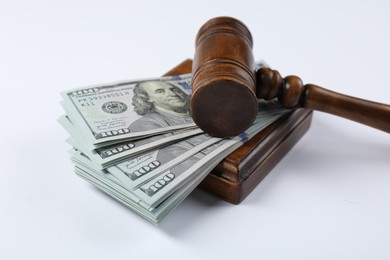 Photo of Judge's gavel and money on white background