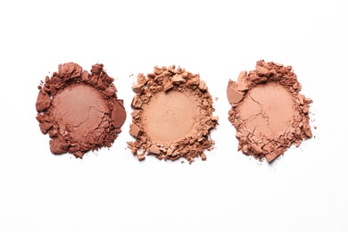Photo of Different crushed eye shadows on white background, top view