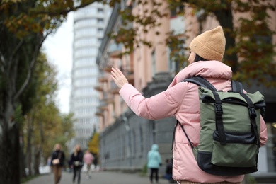 Photo of Young tourist with travel backpack in city on vacation. Space for text