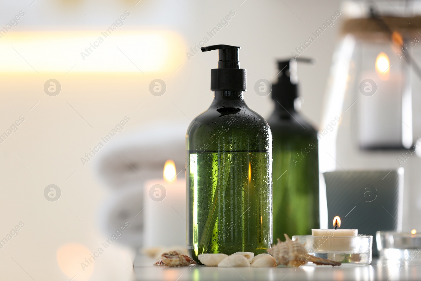 Photo of Soap dispensers and decor elements on table. Space for text