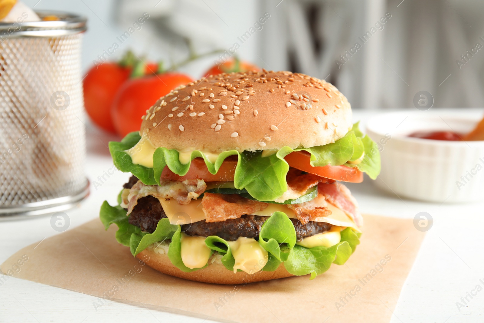 Photo of Tasty burger with bacon served on table