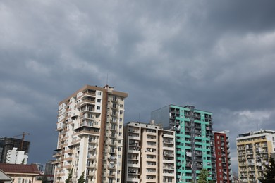 Photo of Beautiful view of multi storey apartment buildings under gloomy sky