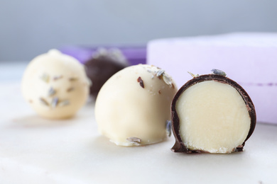 Delicious chocolate candies on white table, closeup