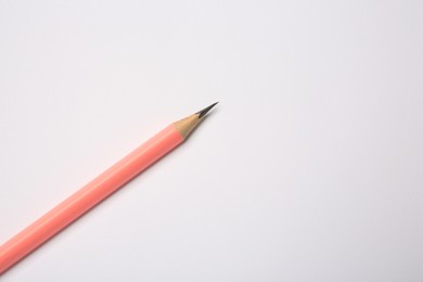 Photo of Sharp graphite pencil on white background, top view. Space for text