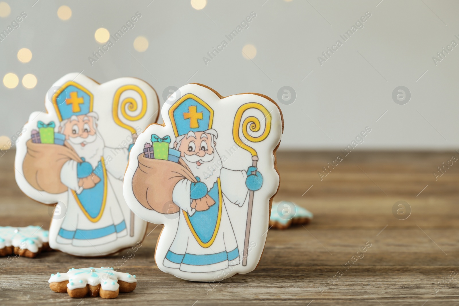 Photo of Delicious gingerbread cookies on wooden table. St. Nicholas Day celebration