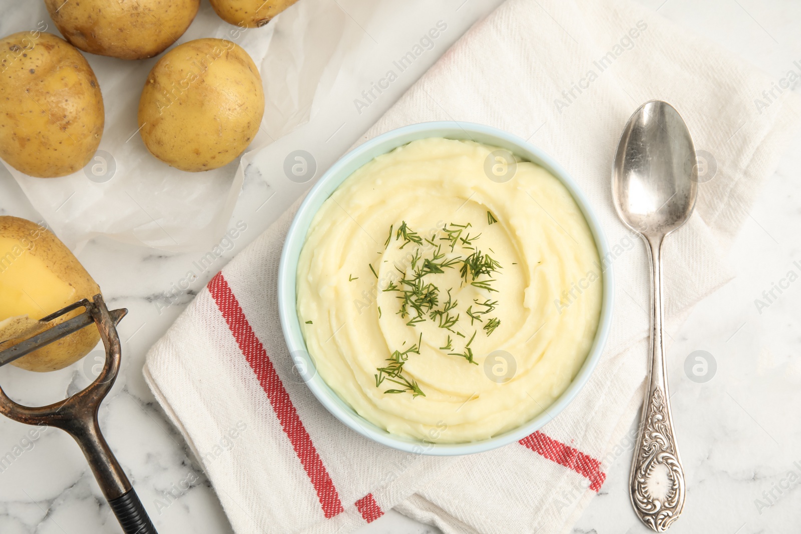 Photo of Freshly cooked homemade mashed potatoes and raw vegetables on white marble table, flat lay