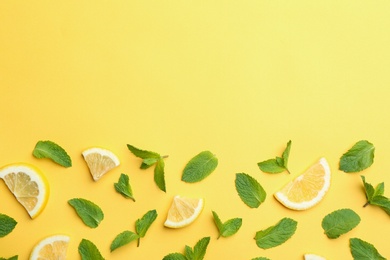 Fresh mint with sliced lemon on yellow background, flat lay. Space for text