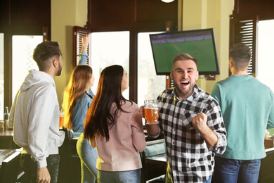 Photo of Group of football fans in sport bar