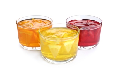 Tasty jelly desserts in glasses on white background