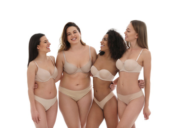 Group of women with different body types in underwear on white background