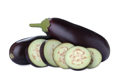 Photo of Cut and whole fresh ripe eggplants on white background