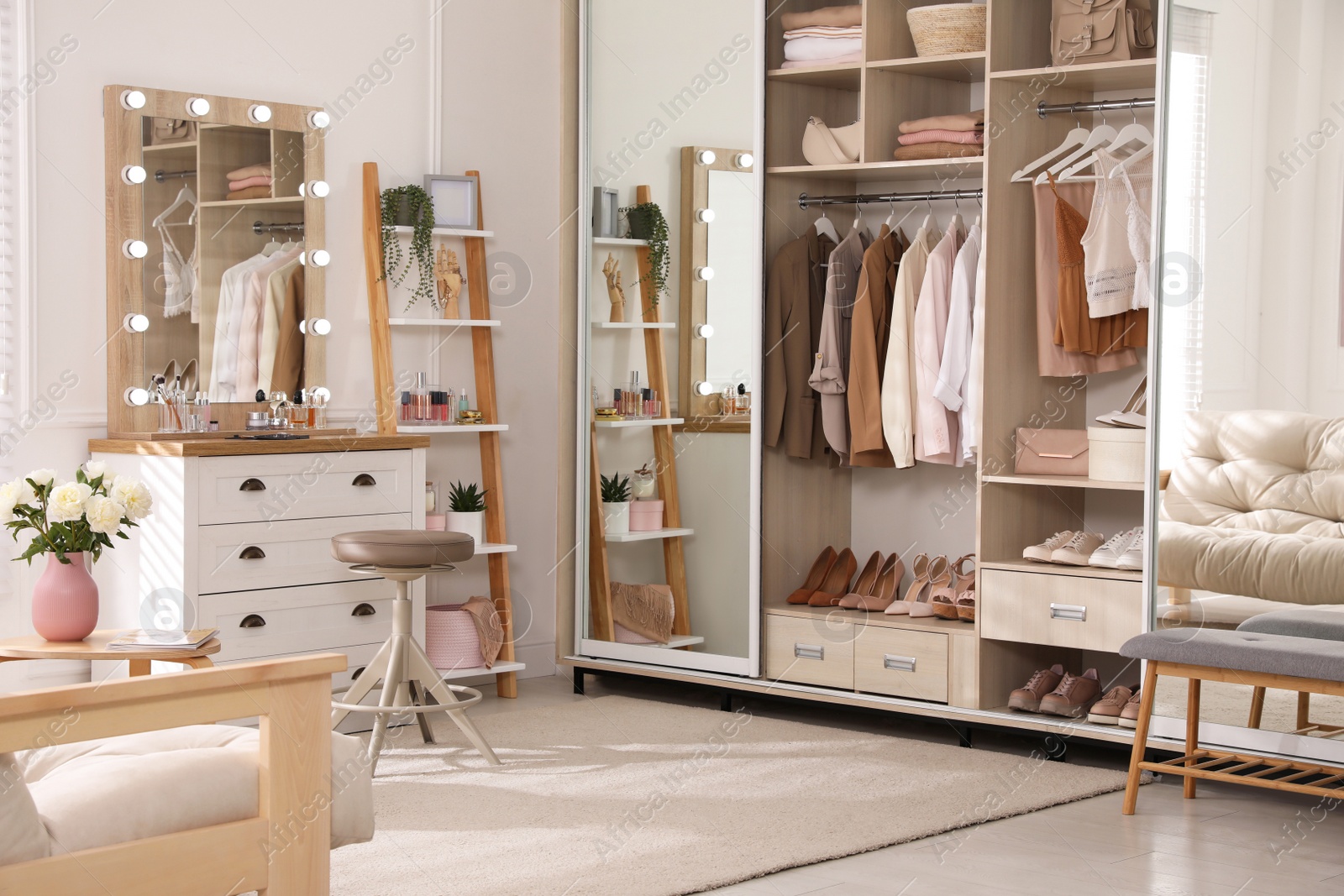 Photo of Elegant room with dressing table and wardrobe. Interior design