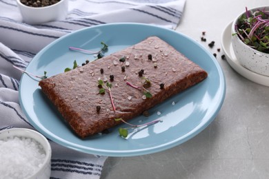 Photo of Fresh raw vegan mince with spices on light grey marble table