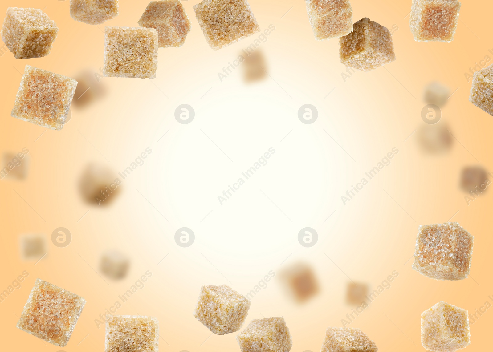 Image of Brown cane sugar cubes falling on golden gradient background