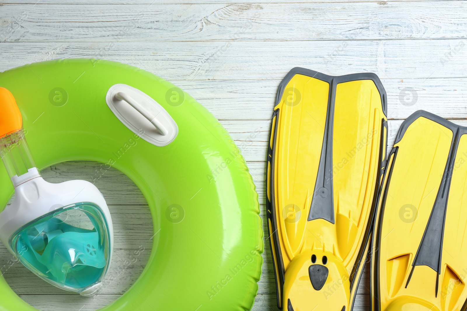 Photo of Flat lay composition with beach accessories on white wooden background