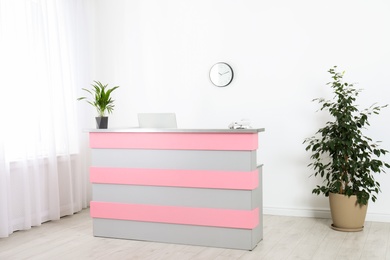 Photo of Modern reception desk in beauty salon. Stylish interior