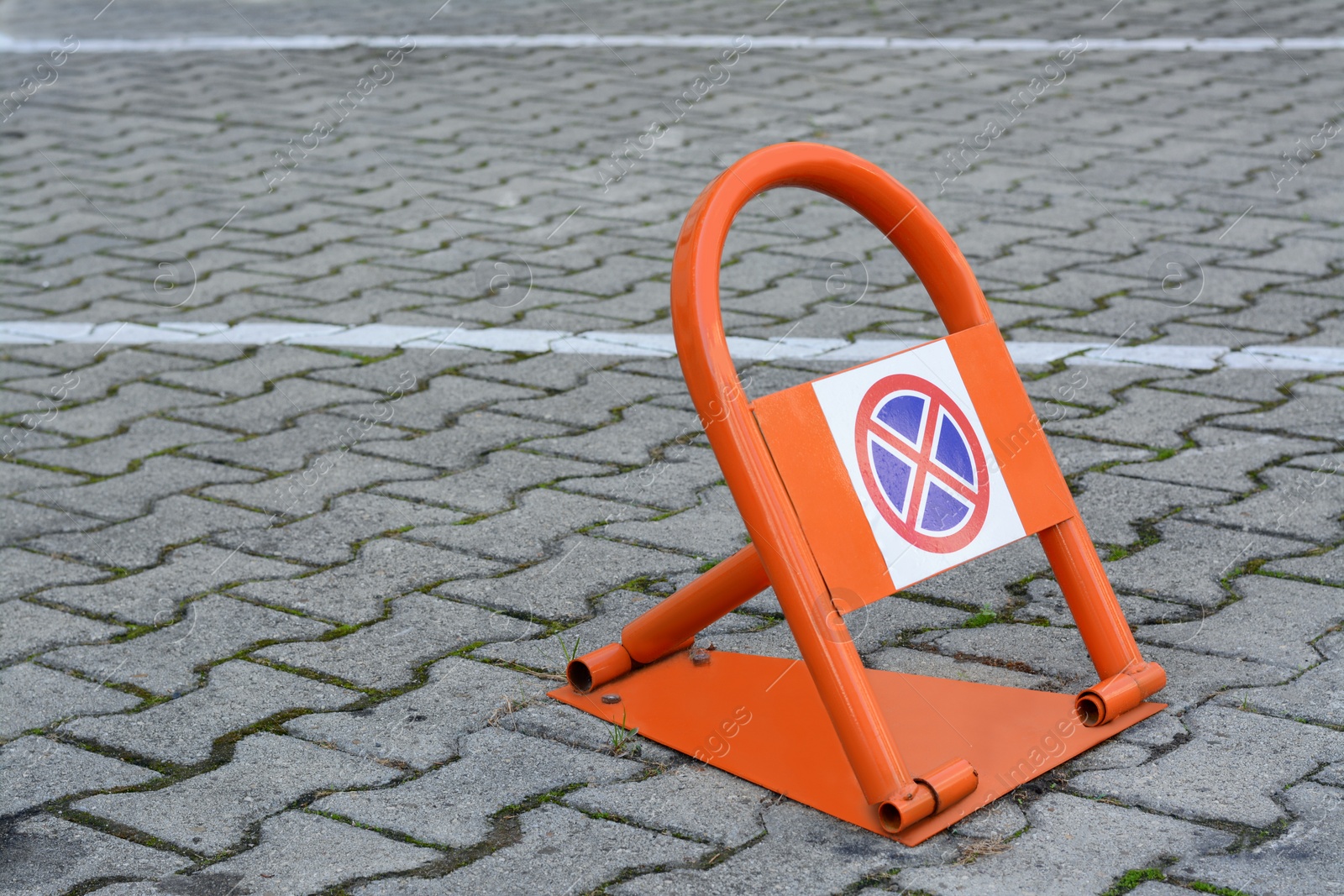 Photo of Parking barrier with No Stopping road sign on pavement outdoors, space for text