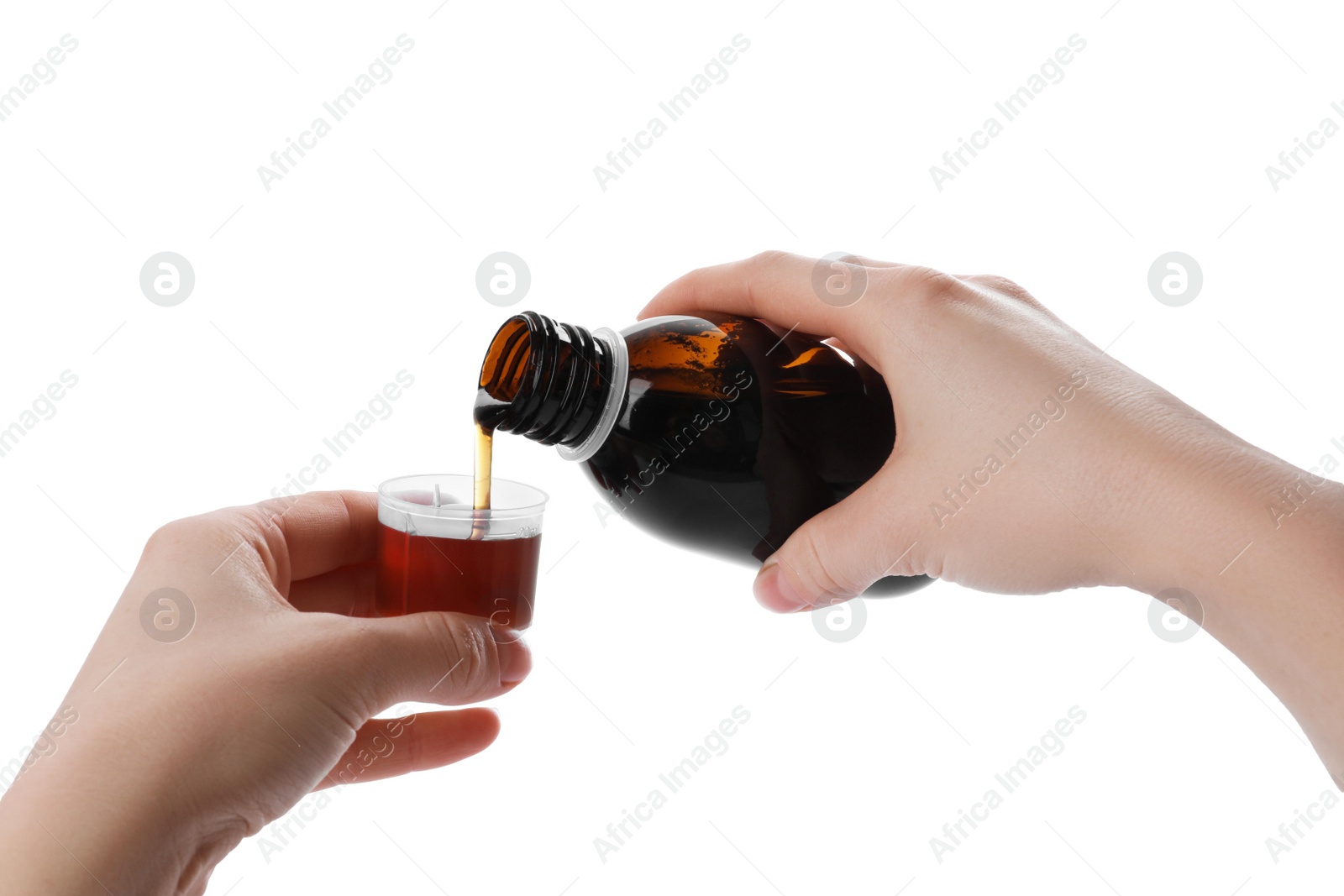 Photo of Woman pouring syrup into measuring cup from bottle isolated on white, closeup. Cough and cold medicine