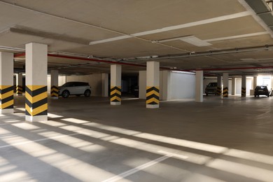 Photo of Open parking garage with cars on sunny day