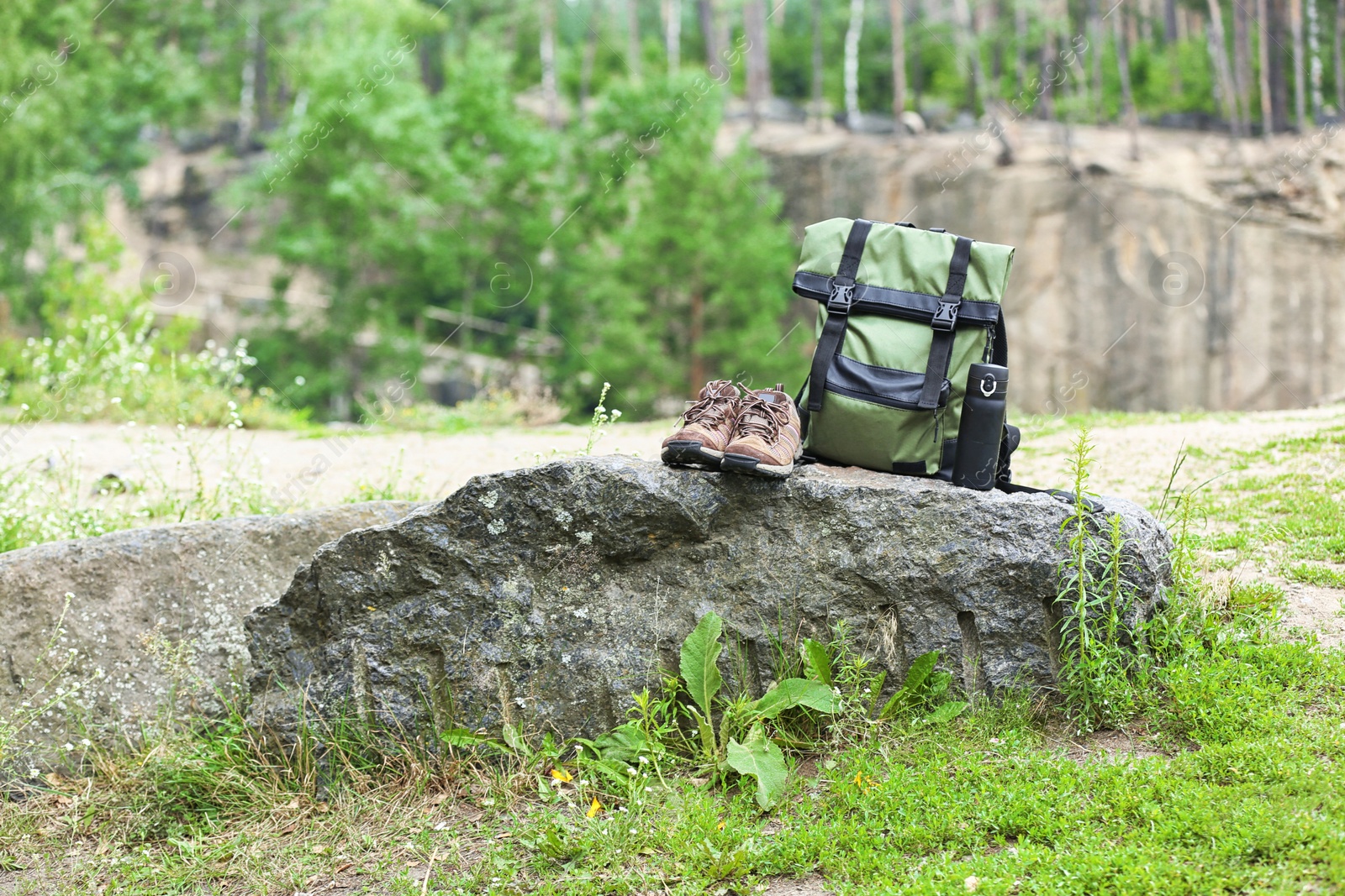 Photo of Set of camping equipment on rock outdoors