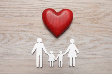 Photo of Paper family cutout and red heart on white wooden background, flat lay. Insurance concept